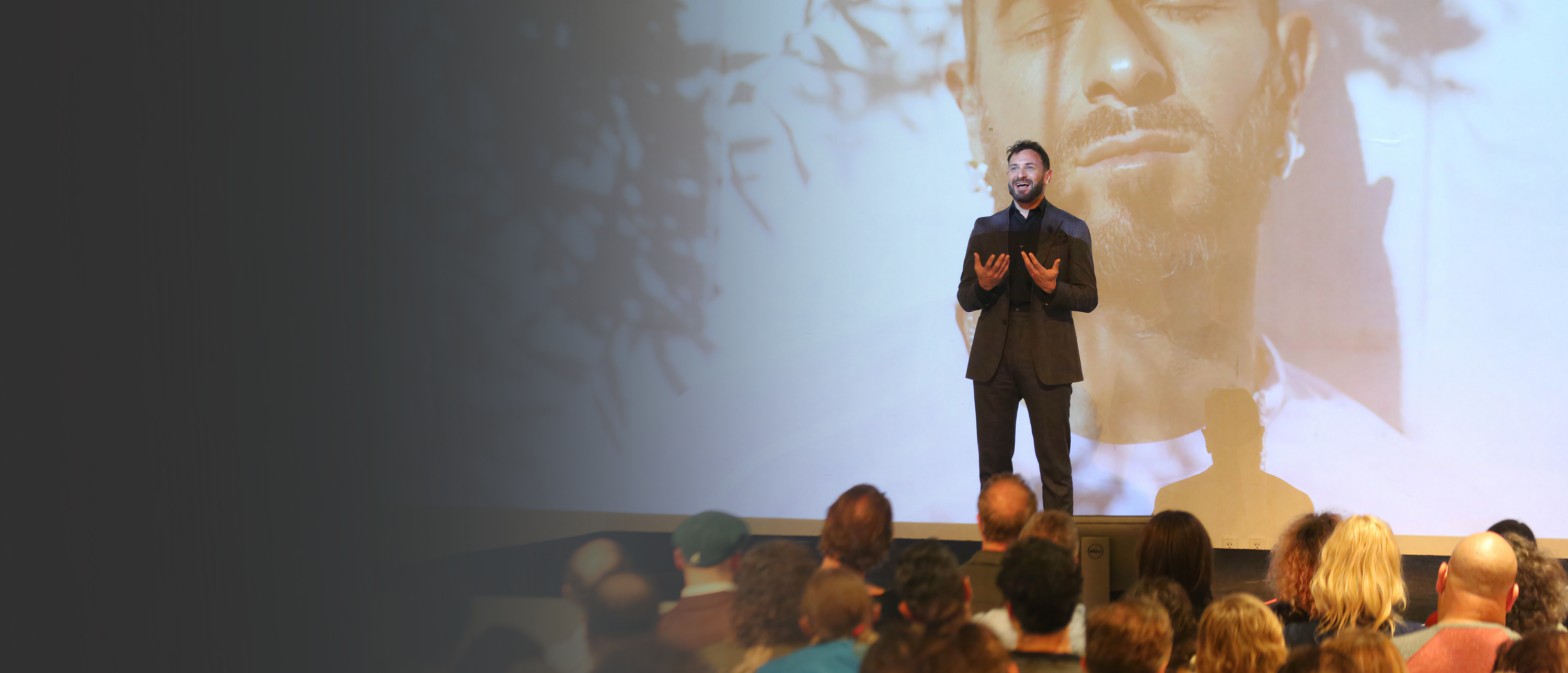 Mischa Byruck, accountability coach, educator and speaker, speaking on stage